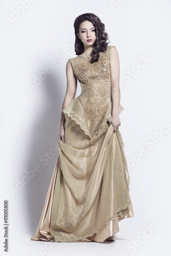 Beautiful woman in golden evening dress.
