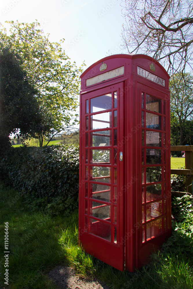 Old fashioned red telephone box in a country village Old fashioned red telephone box in a country village