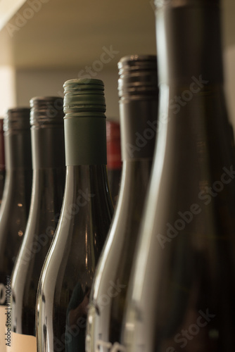 Row of Unlabeled Dark Wine Bottles