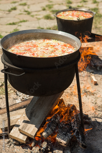 cooking on a fire. fish soup on a fire. pilaf on a fire. food in