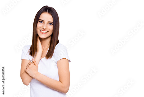 Seductive beauty. Beautiful young woman in white shirt top touching her hair and looking at camera while standing against white background © HBS