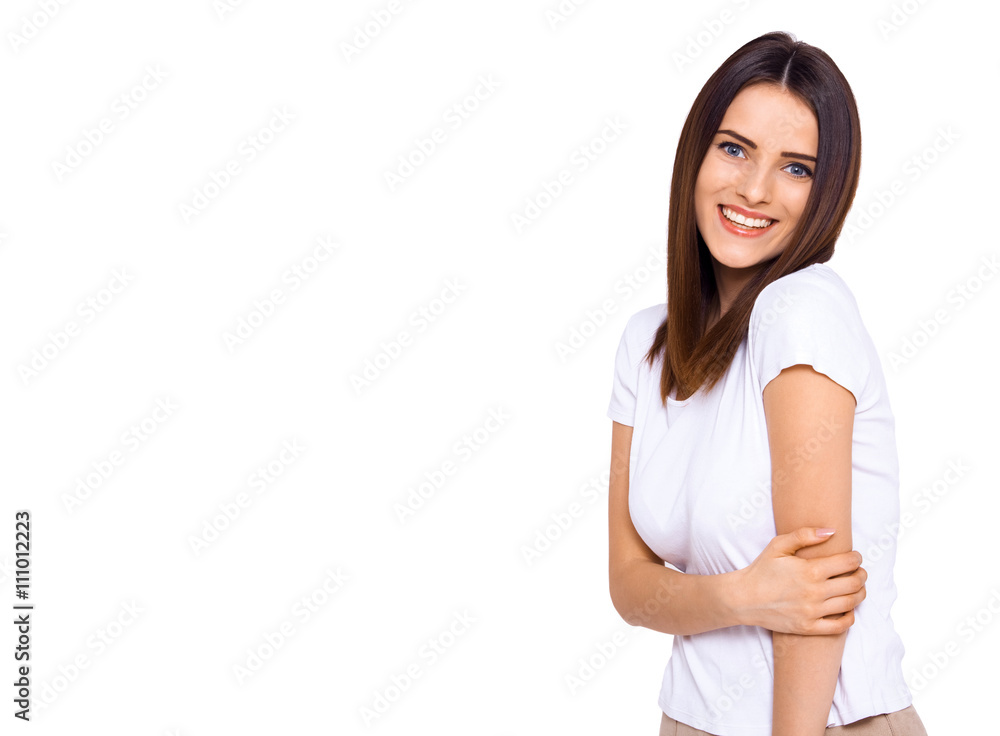 She's on the shy side. Shot of an attractive young woman smiling shyly on a white background She's on the shy side. Shot of an attractive young woman smiling shyly on a white background
