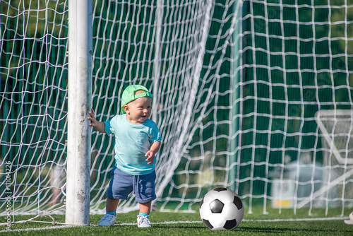 Kid with Ball on a football field