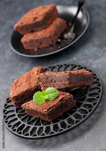 brownies chocolate cake, vertical. Black stone background