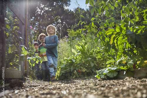 Boys playing hide and seek on allotment photo