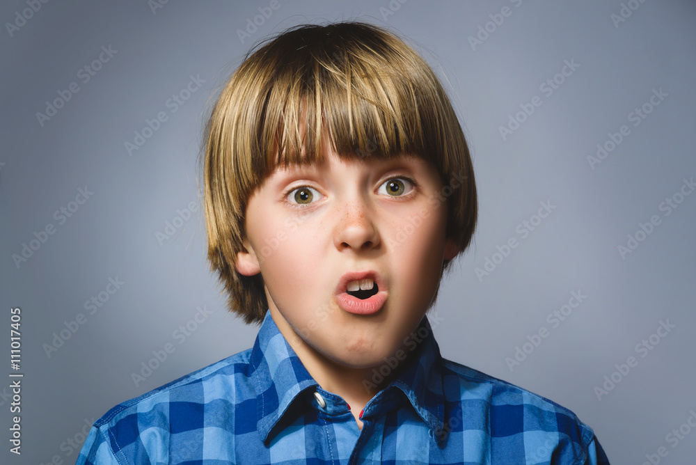 Closeup sad boy with worried stressed face expression Closeup sad boy with worried stressed face expression