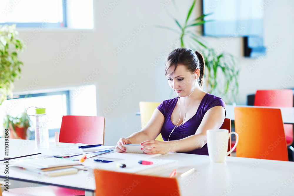Beautiful young student studying in the library or classroom Beautiful young student studying in the library or classroom