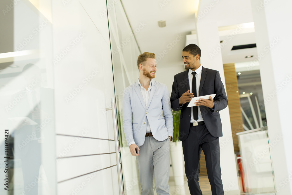 Modern young men with tablet in the office