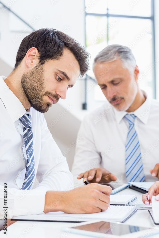 Businessman writing in a diary Businessman writing in a diary