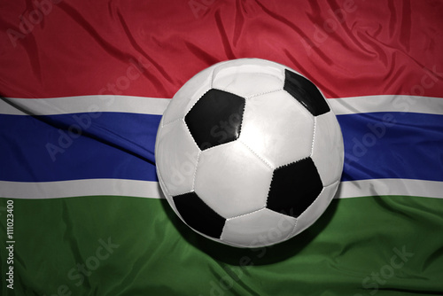 black and white football ball on the national flag of gambia