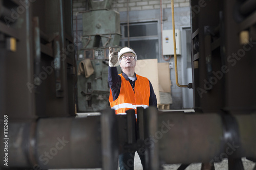 Dock worker giving instruction at port