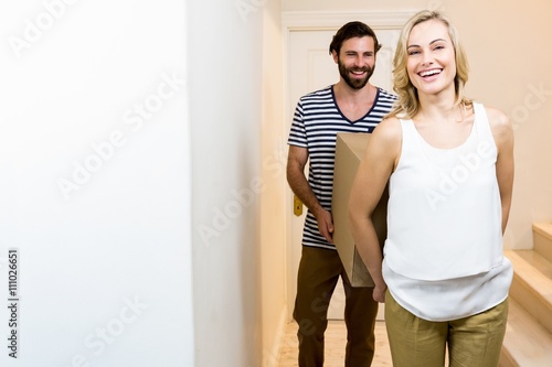 Young couple carrying card board boxes