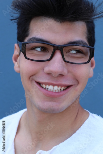 Portrait of handsome man wearing optical glasses isolated on blue. Young stylish Caucasian male model posing in studio.