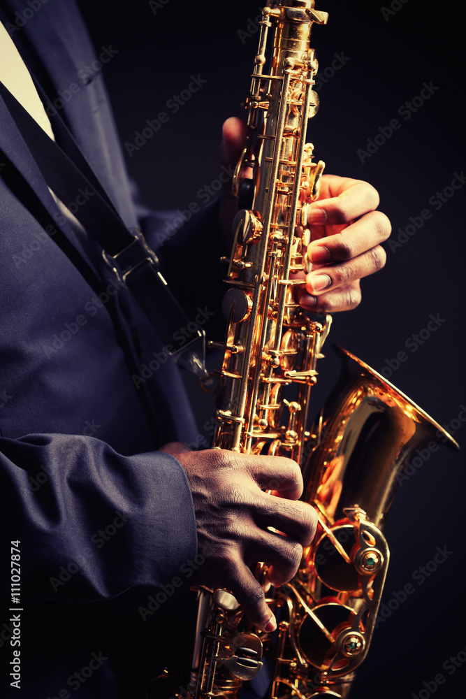Fototapeta premium African American jazz musician playing the saxophone, closeup