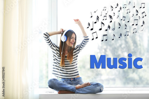 Woman with headphones liste...