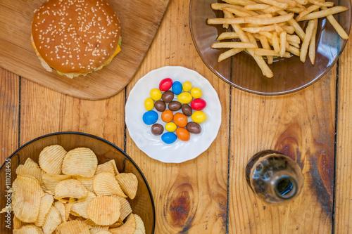 Fast food set big hamburger and french fries on wood background