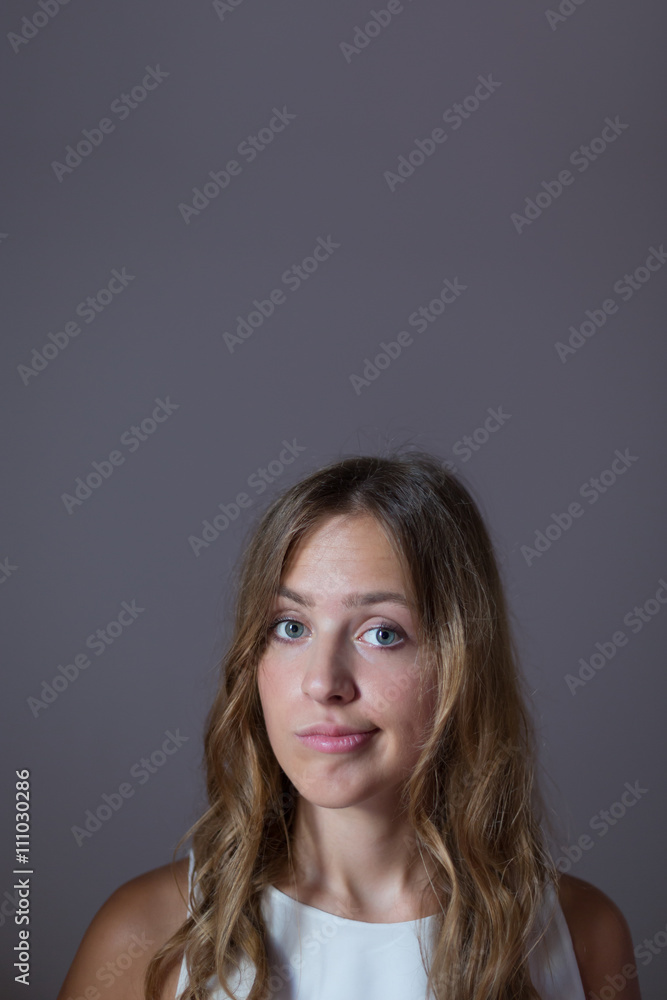 Fototapeta premium Stunning brunette in studio wearing white dress