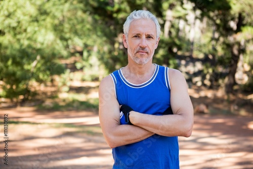 Mature man posing with arms crossed
