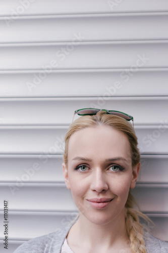 Candid portrait of young blonde woman looking down against corru photo