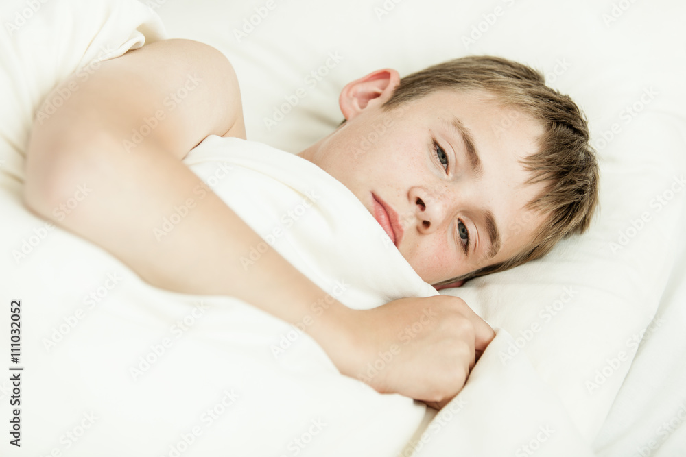 Close up of tired boy in bed Close up of tired boy in bed