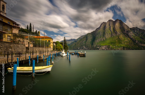 Harbor of Riva di Solto on Iseo Lake with mountains on background, Italy