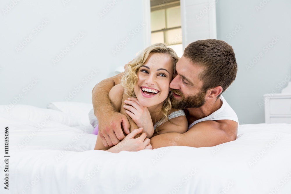 Young couple embracing on bed Young couple embracing on bed