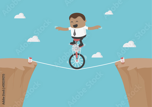 Young African businessman balancing on the rope