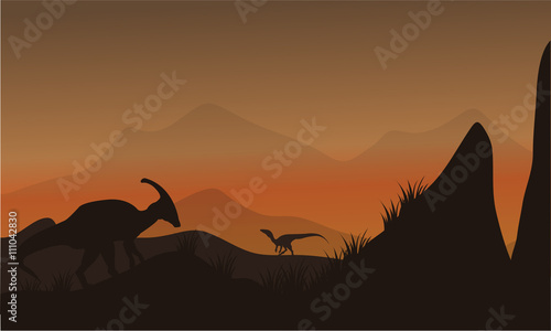 Fotografie, Obraz On the hills silhouette eoraptor and parasaurolophus