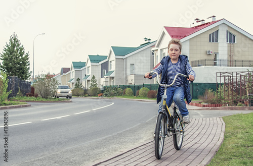 boy on bike riding along the street