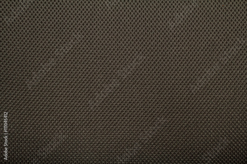 Dark brown fishnet cloth material as a texture background.