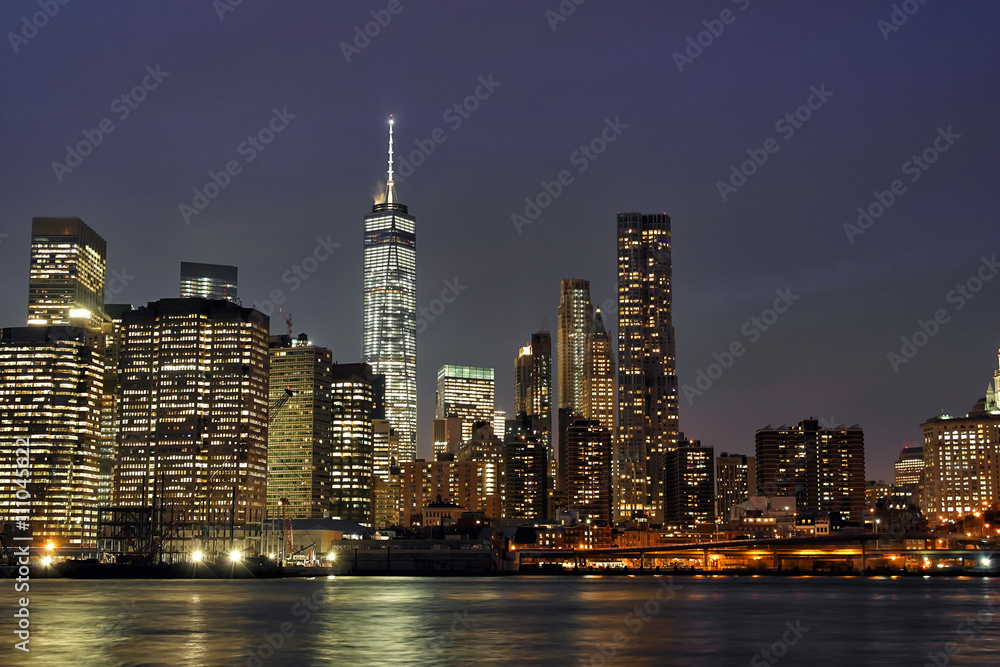 Downtown Manhattan at night with the new World Trade Center and East River