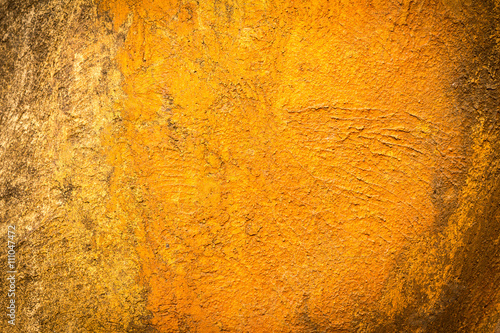 Abstract background texture cement wall in orange yellow tone.