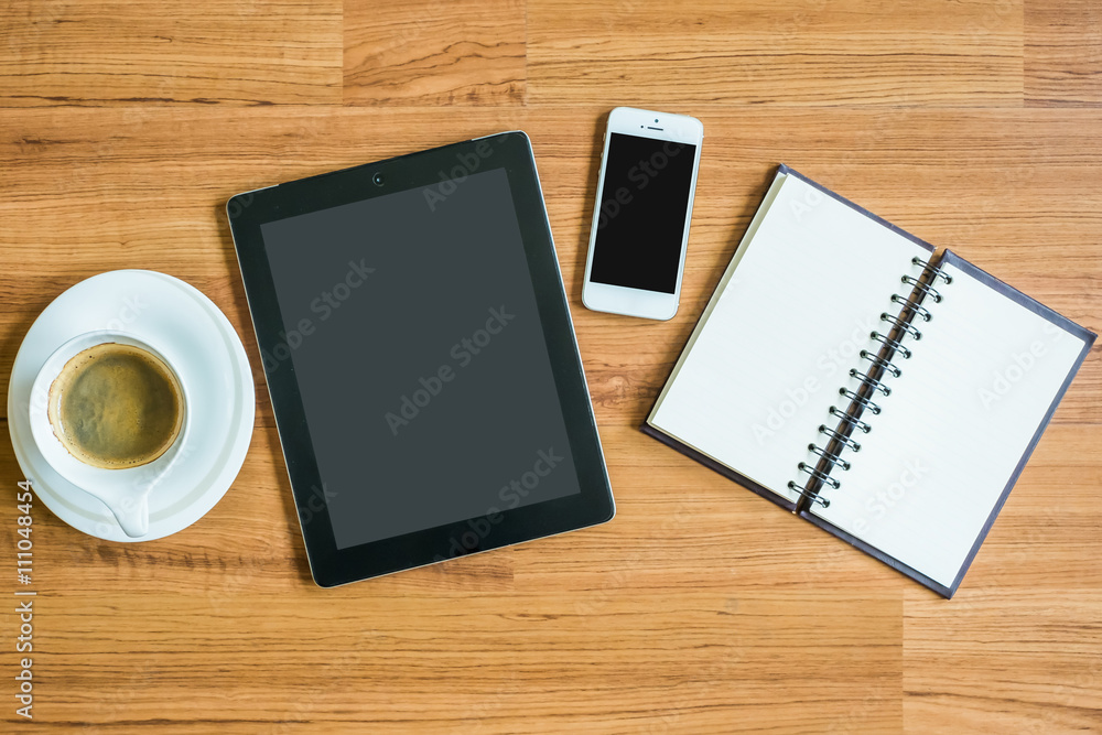 tablet, smart phone, coffee and note on the wood table tablet, smart phone, coffee and note on the wood table