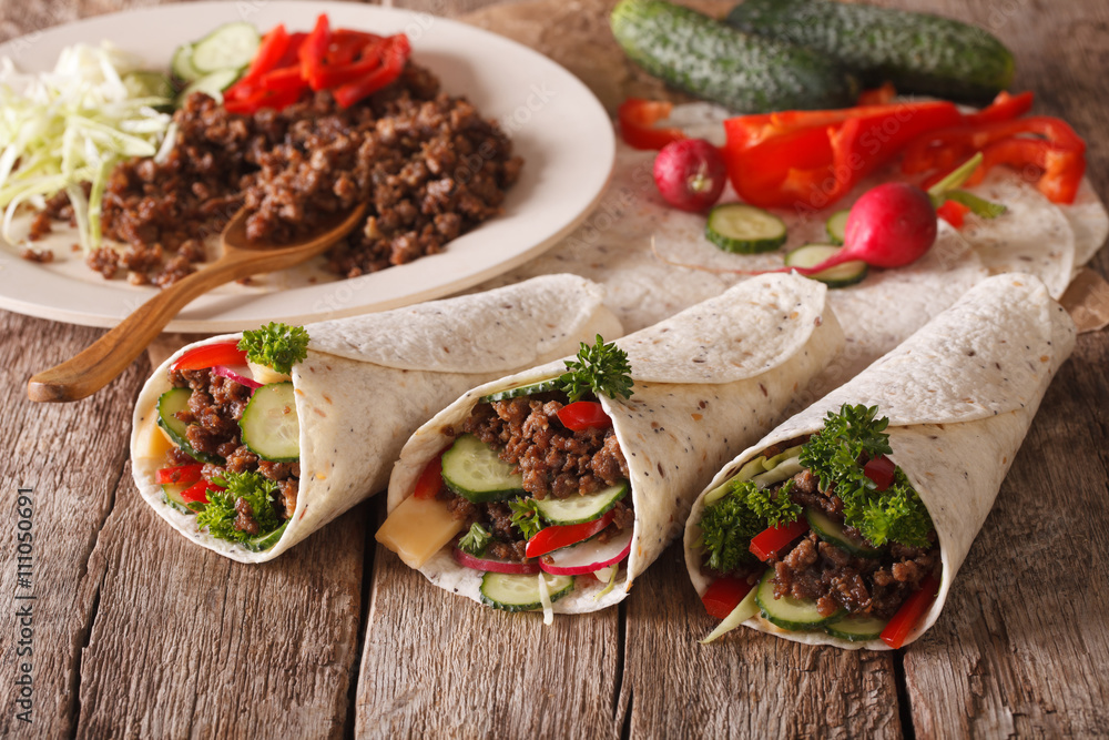 Sandwich roll stuffed with beef and vegetables close-up. horizontal
Sandwich roll stuffed with beef and vegetables close-up. horizontal