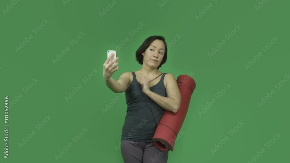 caucasian sporty girl with yoga mat isolated on green screen taking selfie caucasian sporty girl with yoga mat isolated on green screen taking selfie