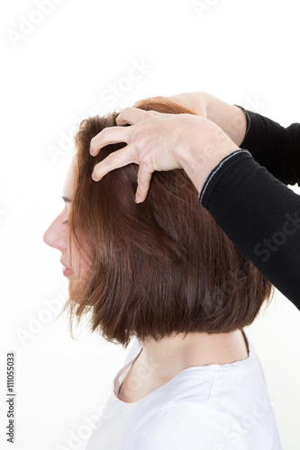 Woman getting a massage while having hair cut at salon by hairdresser