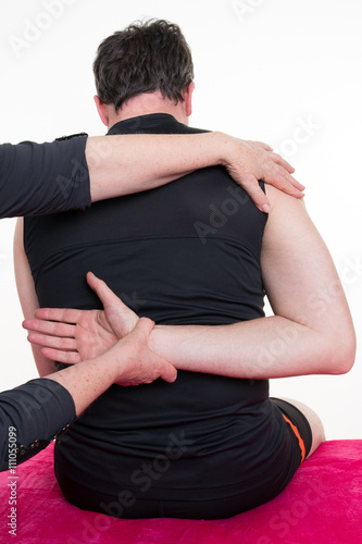 Physiotherapist doing back massage in medical office