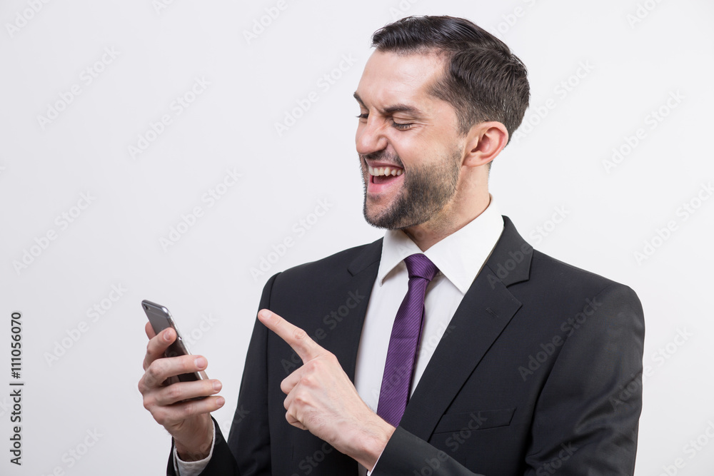 Young business man checks his phone