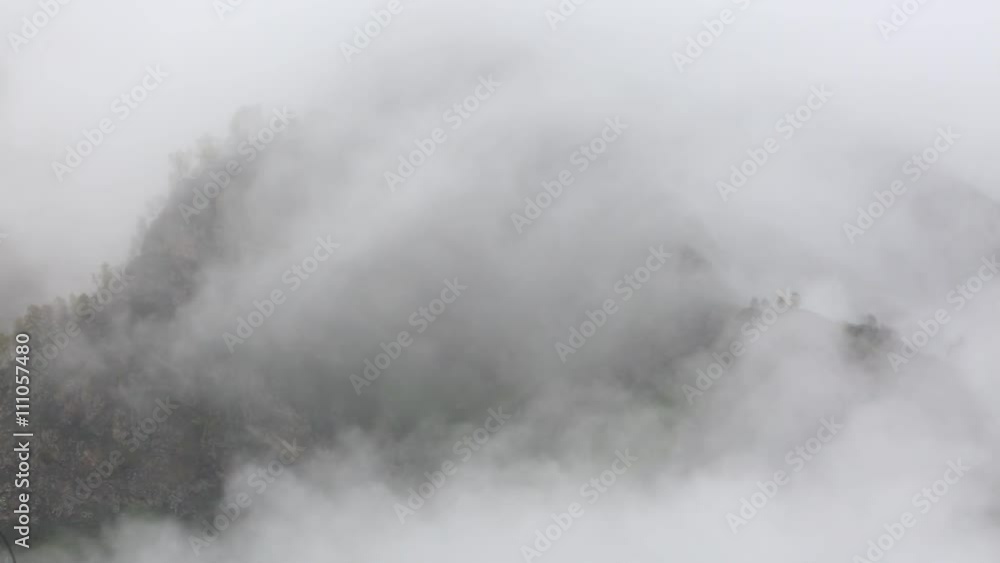 Russia. In early spring the dense veil of mist and clouds creeping up the steep mountain slopes of the Central Caucasus peaks. Russia. In early spring the dense veil of mist and clouds creeping up the steep mountain slopes of the Central Caucasus peaks.