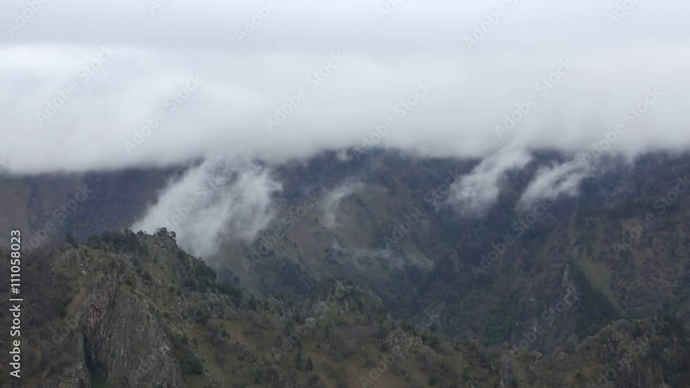 Russia. In early spring the dense veil of mist and clouds creeping up the steep mountain slopes of the Central Caucasus peaks. Russia. In early spring the dense veil of mist and clouds creeping up the steep mountain slopes of the Central Caucasus peaks.