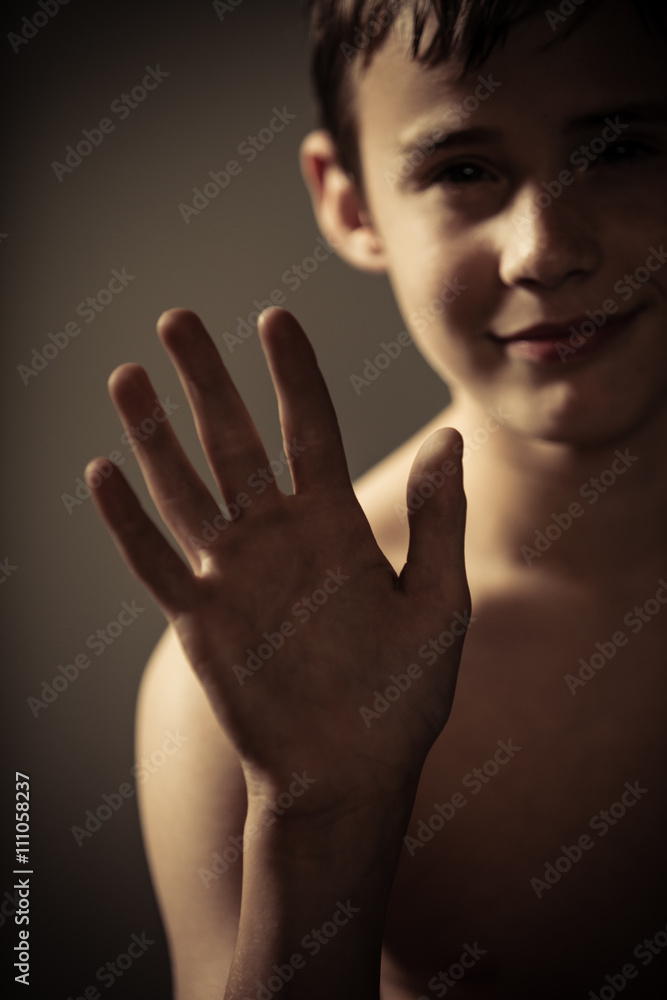 Shirtless Teenage Boy with Hand Raised at Camera Stock Photo | Adobe Stock