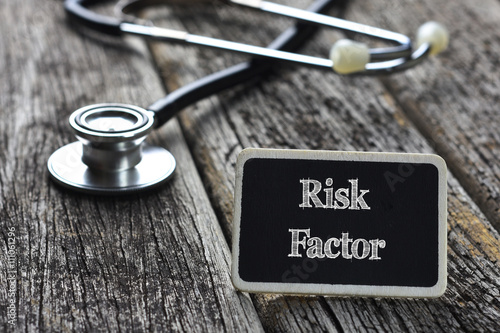 Medical Concept-Risk Factor word written on blackboard with Stet