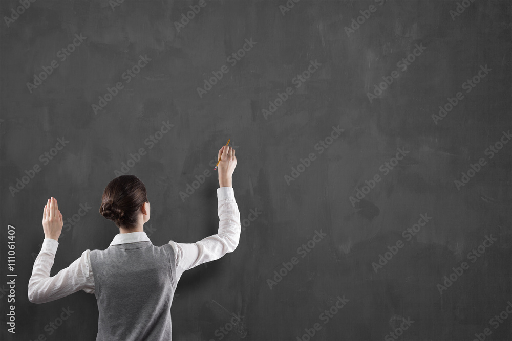 businesswoman drawing on chalkboard businesswoman drawing on chalkboard