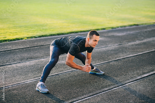 man stretches the body before running