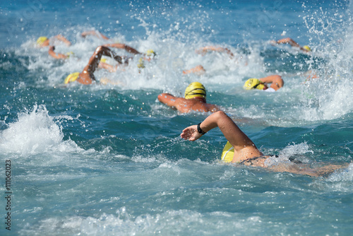 Obraz na płótnie Swimming athletes in a triathlon contest