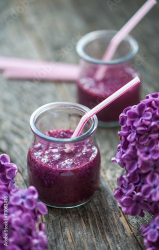 Blueberry smoothie in small glasses on a wooden  table