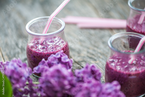 Blueberry smoothie in small glasses on a wooden  table