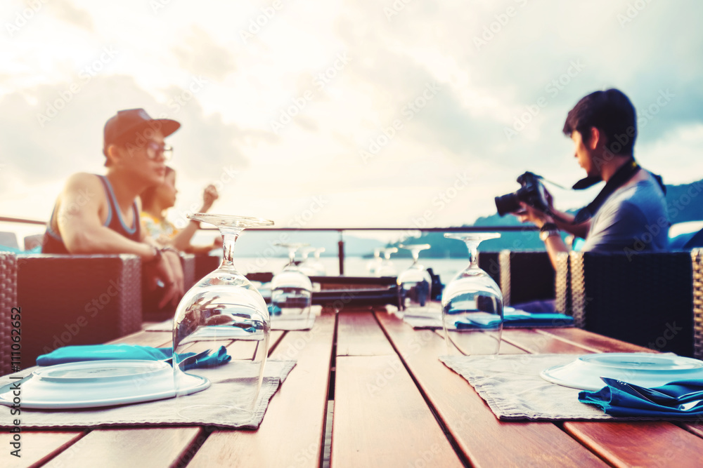 Dinner preparation on desk on the island with friends group in sunset, vintage tone, selective focus