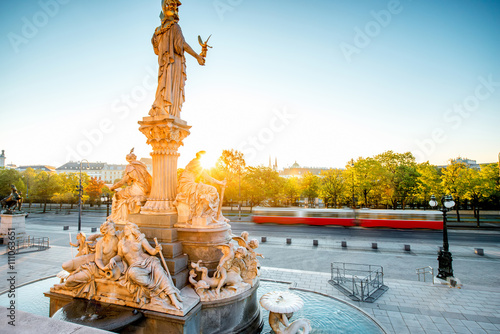 Photography Athena statue near Parlament building with Vienna cityscape and old tram on the