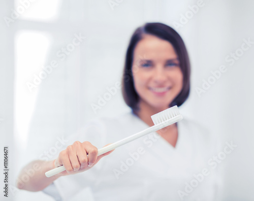 dentist with toothbrush in hospital